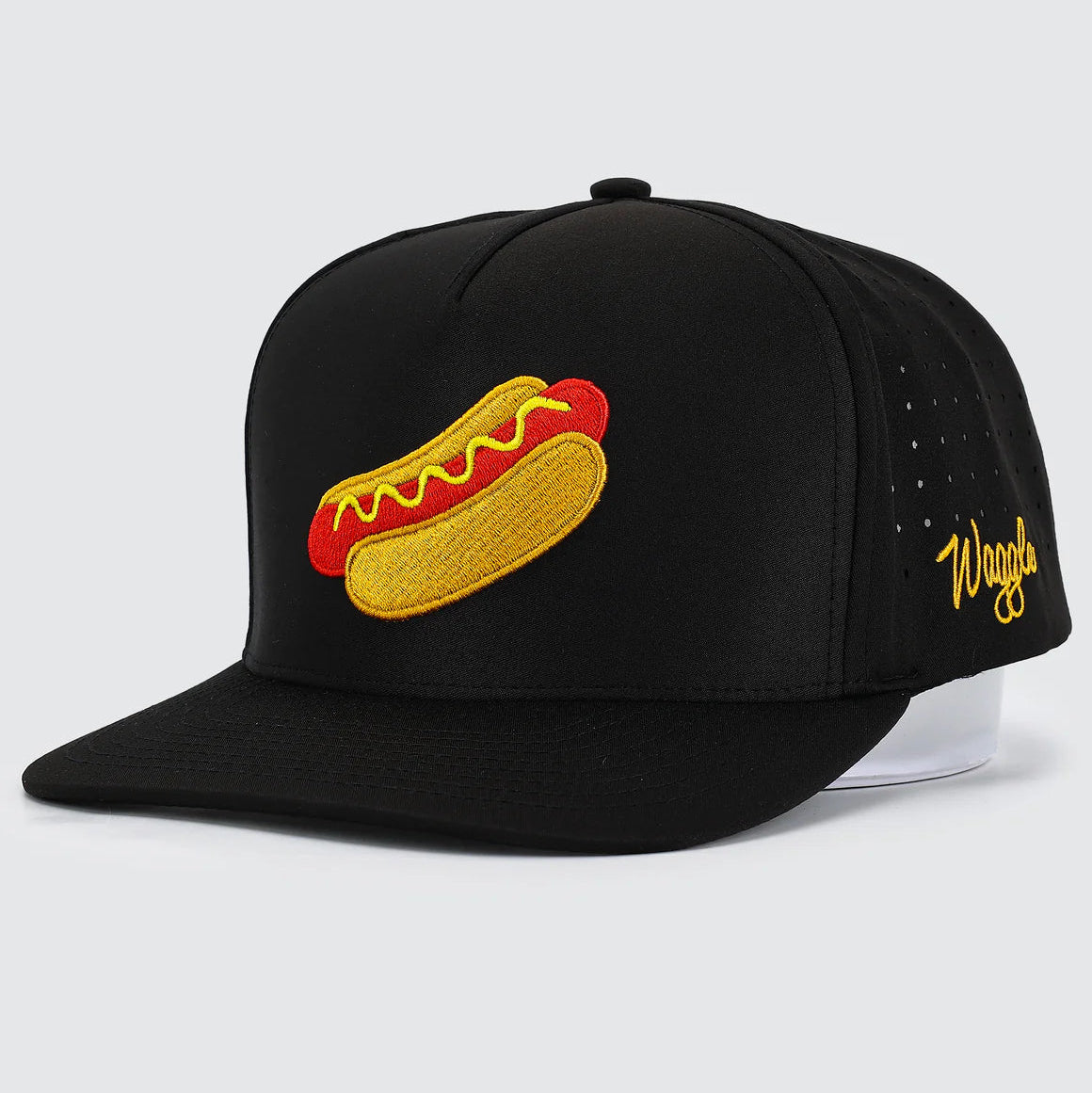 Black cap with a hot dog graphic and 'Waggle' branding on a light gray background