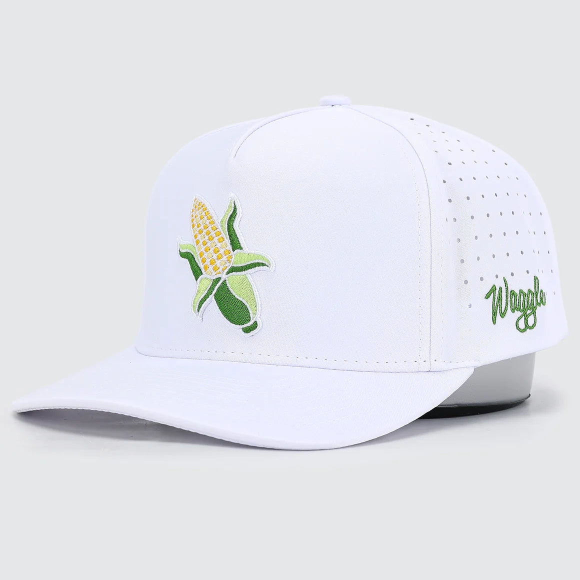 White cap with corn design and 'Waggle' branding on a light gray background